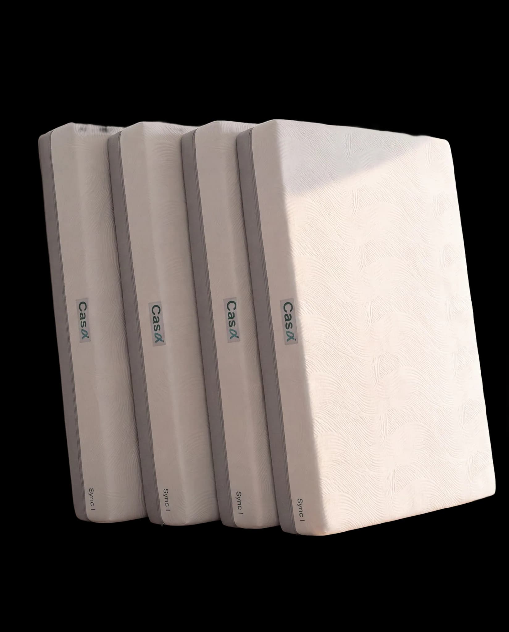 Four Sync mattresses leaning in a stagger, cut out on a transparent background.